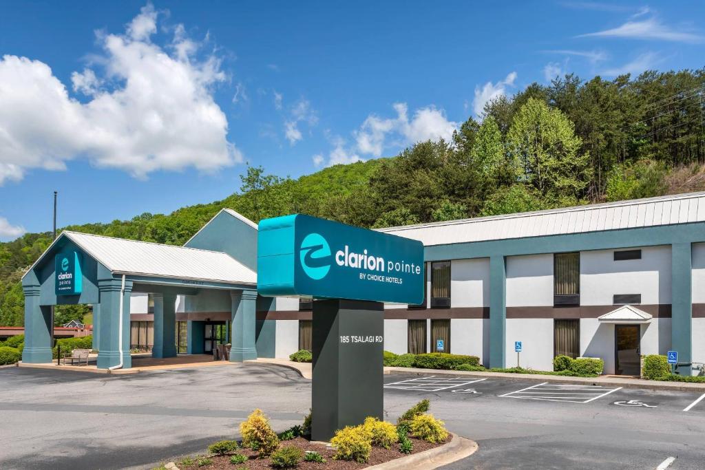 a building with a sign in front of it at Clarion Pointe Cherokee in Cherokee