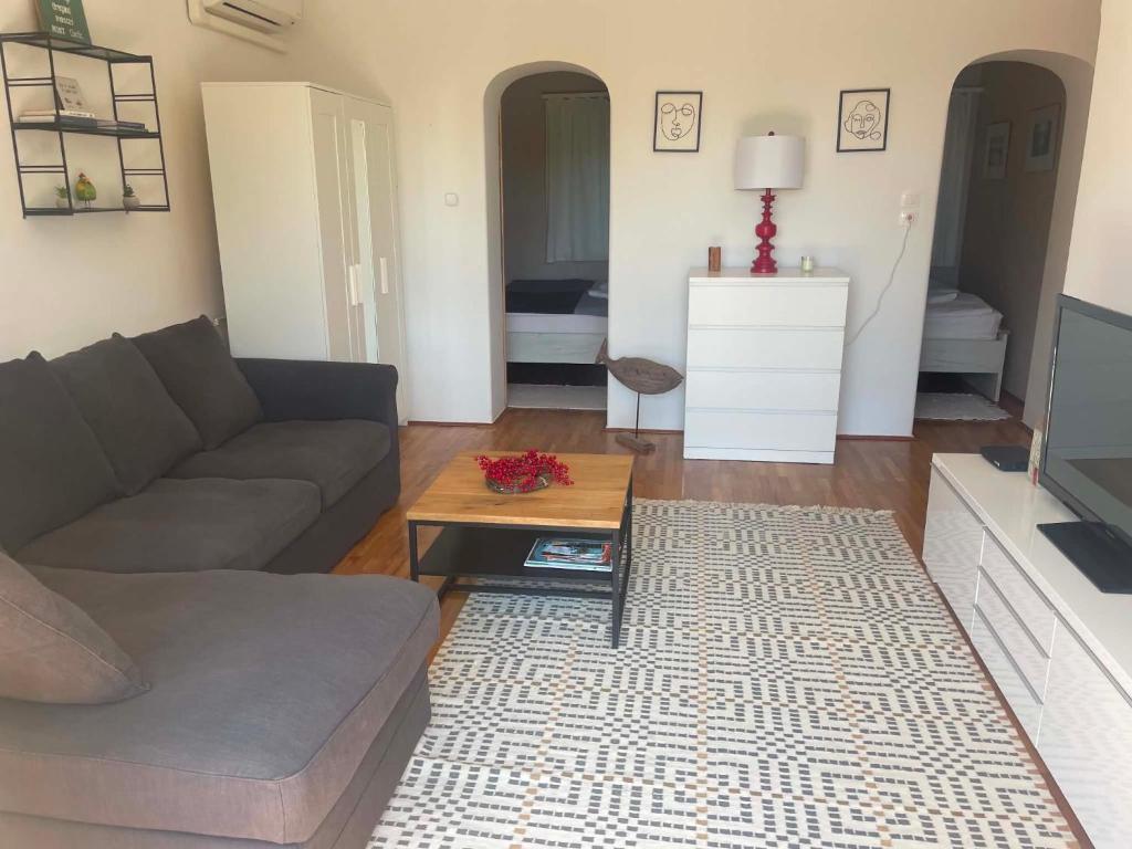 a living room with a couch and a coffee table at Soós Apartman in Balatonfüred
