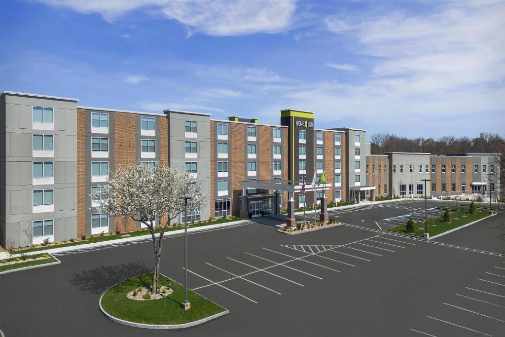 a rendering of a hotel with a parking lot at Home2 Suites by Hilton Chelmsford Lowell in Chelmsford