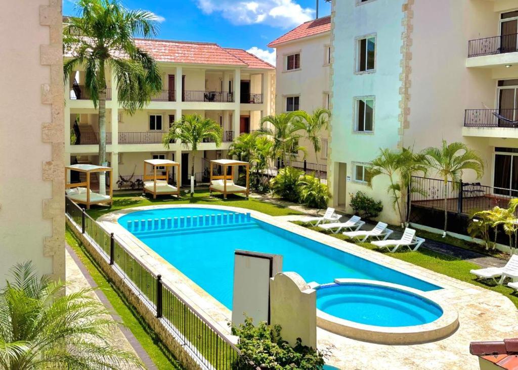 an image of a swimming pool in front of a building at Seven beaches Palmeral in Punta Cana