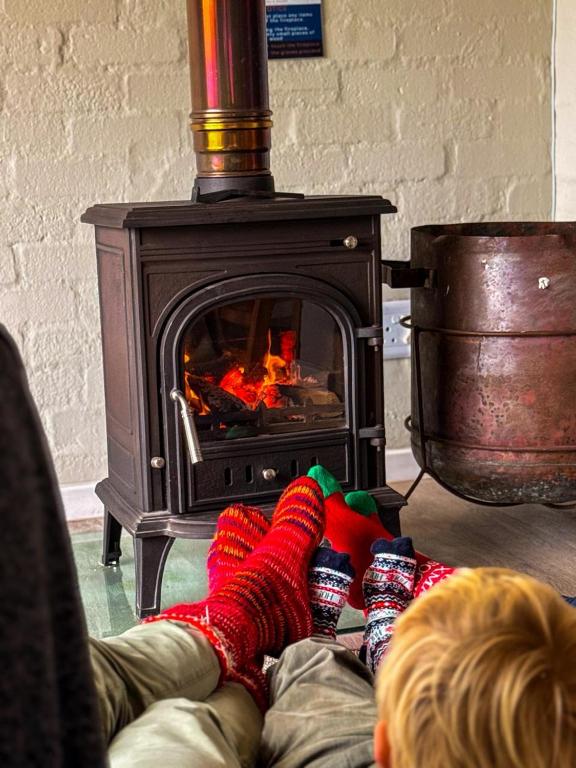 a person laying on the floor in front of a stove at Blue Bay Lodge in Saldanha