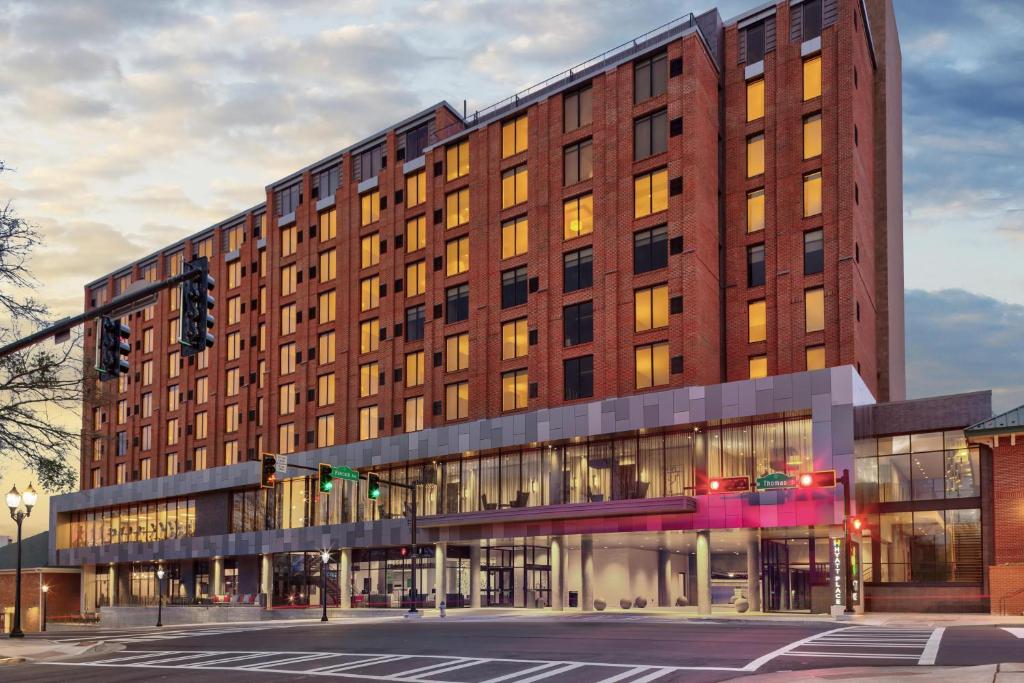 a large brick building on a city street at Hyatt Place Athens Downtown in Athens