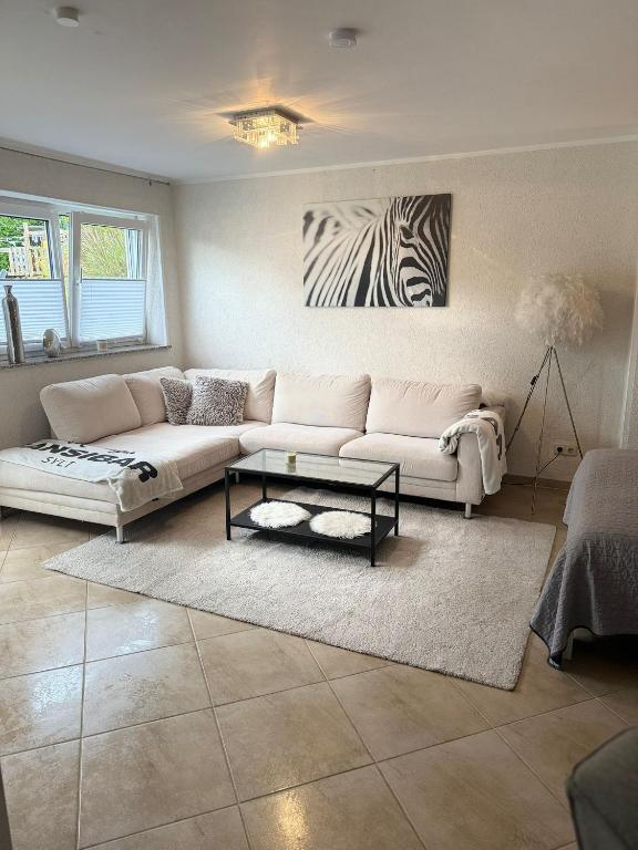 a living room with a couch and a zebra painting at Monteurwohnung,Ferienwohnung in Lüdenscheid