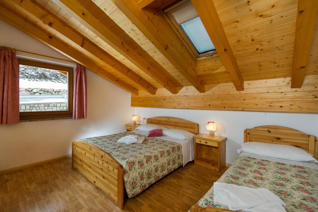Łóżko lub łóżka w pokoju w obiekcie Residence Villa Boschetto