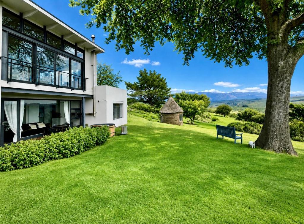 a house with a green lawn and a tree at Elgin Views with Hot Tub in Ouda Brug