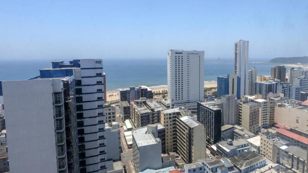 an aerial view of a city with buildings and the ocean at Seaboard Apart Hotel in Durban