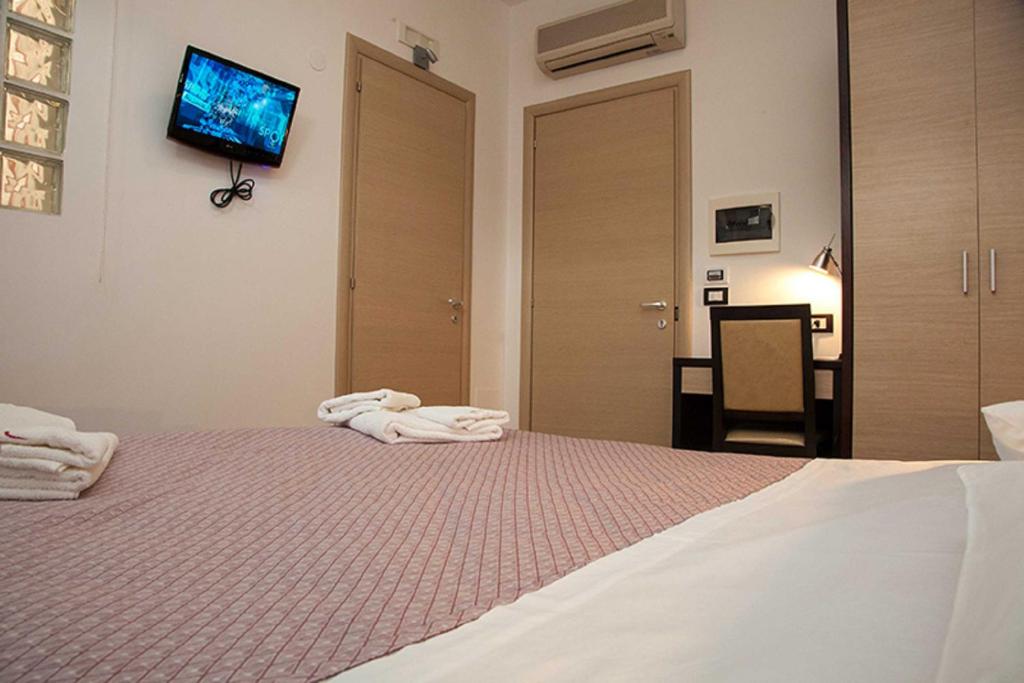 Postel nebo postele na pokoji v ubytování Albergo Perseo