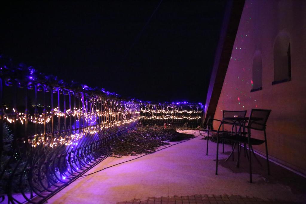 a row of lights on a fence at night at Motel Orgován in Moldava nad Bodvou