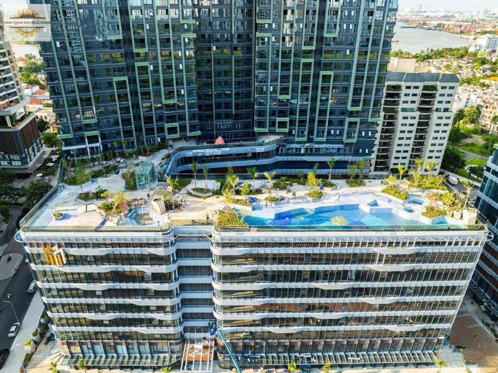 a large building with a swimming pool on top of it at Lumiere Riverside Grand Prestige Residence in Ho Chi Minh City