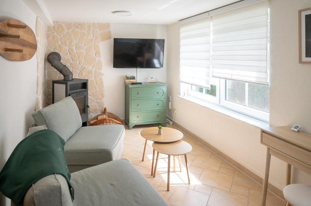 a living room with a couch and a tv and a table at Strandhaus 134 in Mönkebude