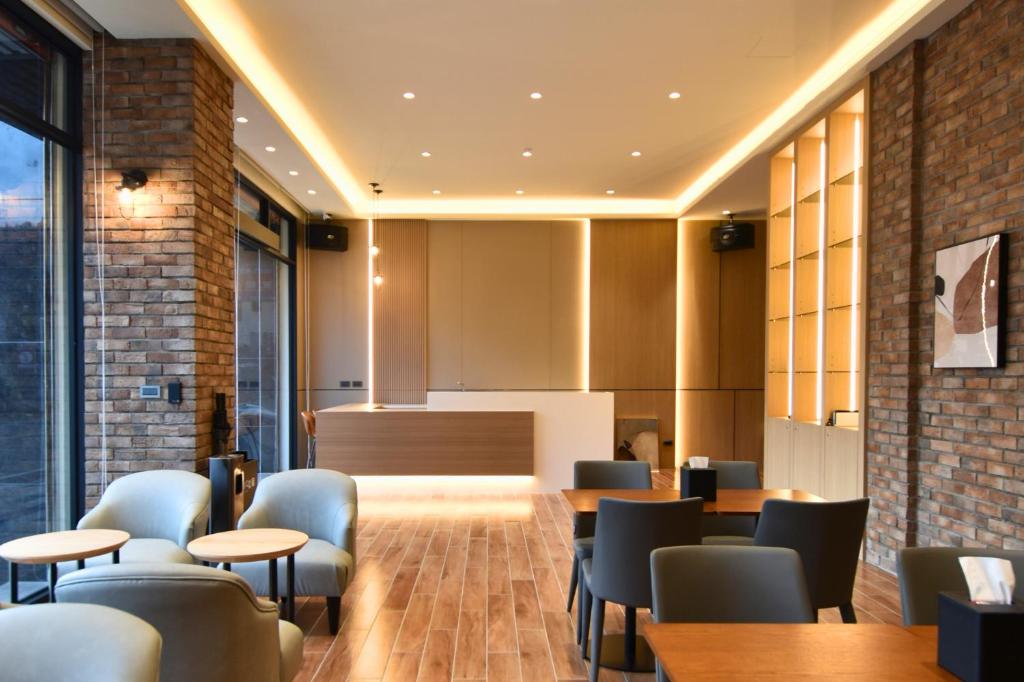 a restaurant with tables and chairs and a counter at Cheng House in Yuchi