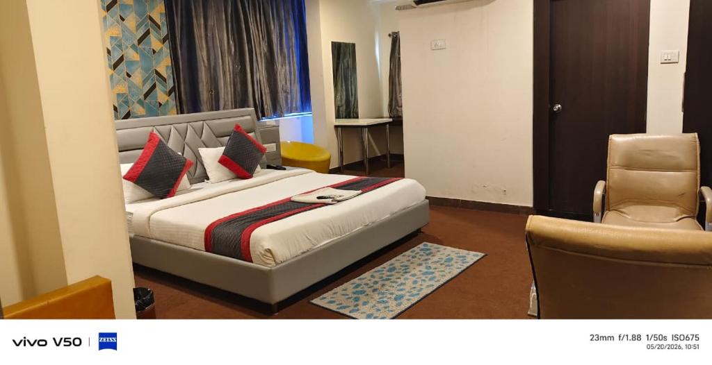 a hotel room with a bed and a chair at ABI RESIDENCY Hitech City in Hyderabad
