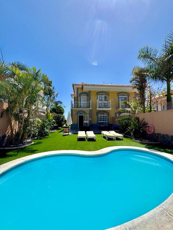 a large pool in front of a house at Villa Lady Luxury - Private Pool - Costa Adeje in Adeje