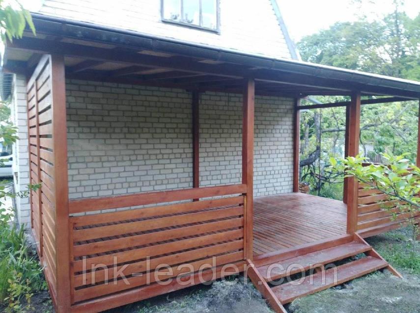 a wooden gazebo in front of a house at Садиба in Vinnytsya