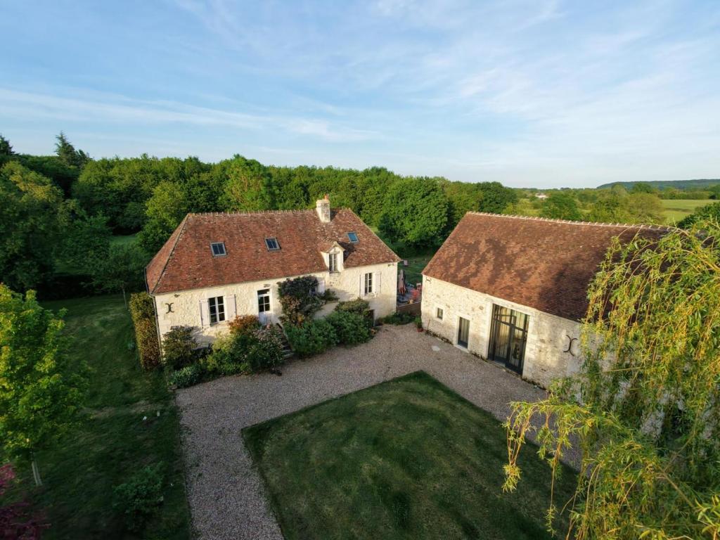an aerial view of a house with a yard at Domaine de La Vove - Maison d'hôtes classée, cadre paisible et naturel - ambiance insolite jardin paysager doté d'une terrasse spacieuse - une vue panoramique exceptionnelle -authenticité et élégance in Corbon