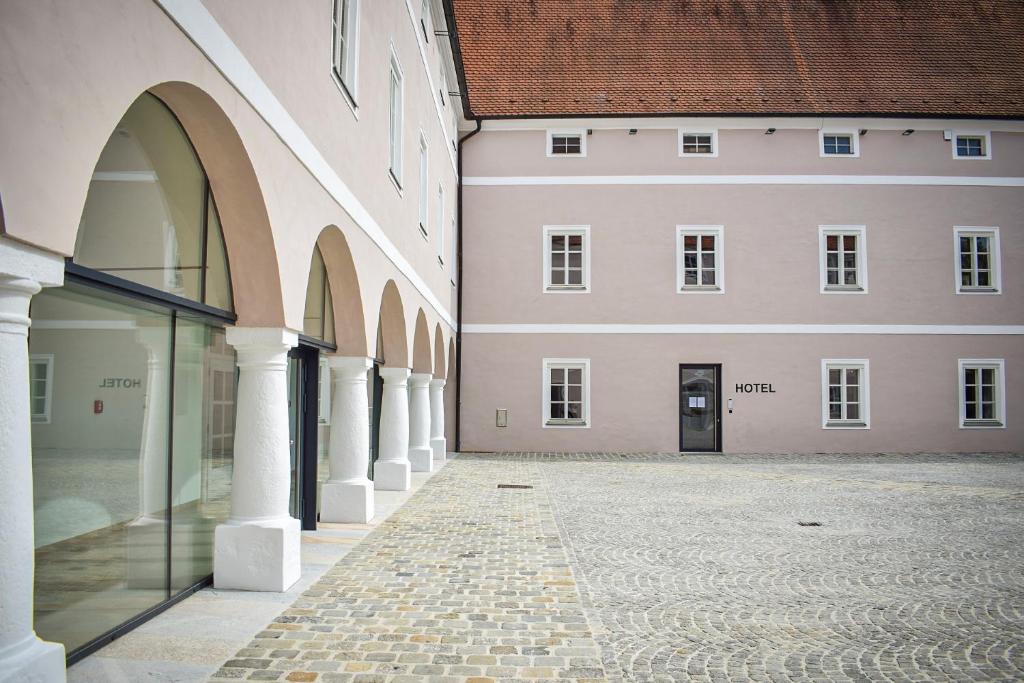 an empty courtyard of a building with a door at Schloss Hotel Zeillern in Zeillern