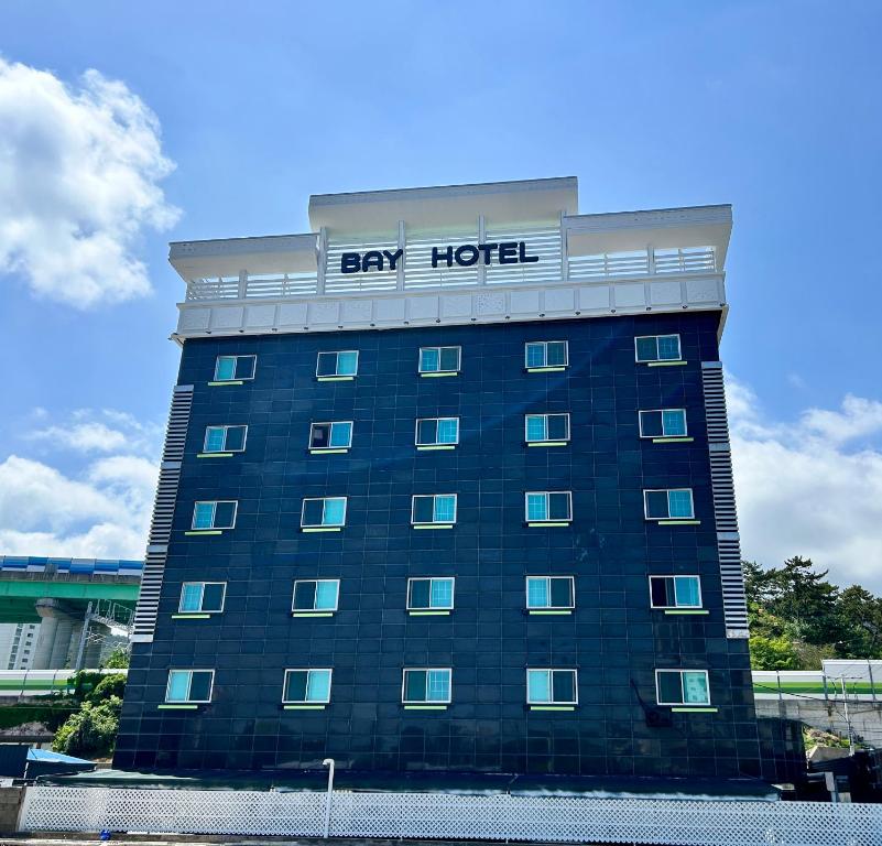 a large building with a bay hotel sign on it at Song-Jeong Bay Hotel in Busan