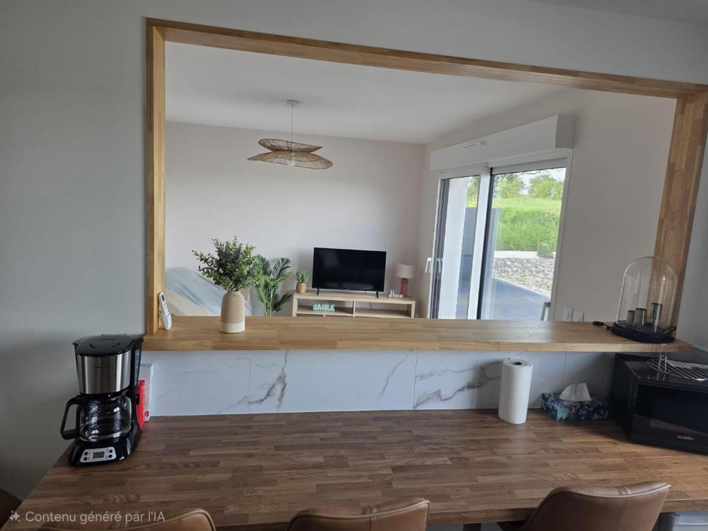 a living room with a counter with a mirror at L'Escale de la Râperie logement 4 in Tincourt-Boucly