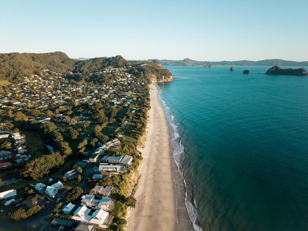 an aerial view of a beach and the ocean at Tasman Holiday Parks - Hahei Beach in Hahei