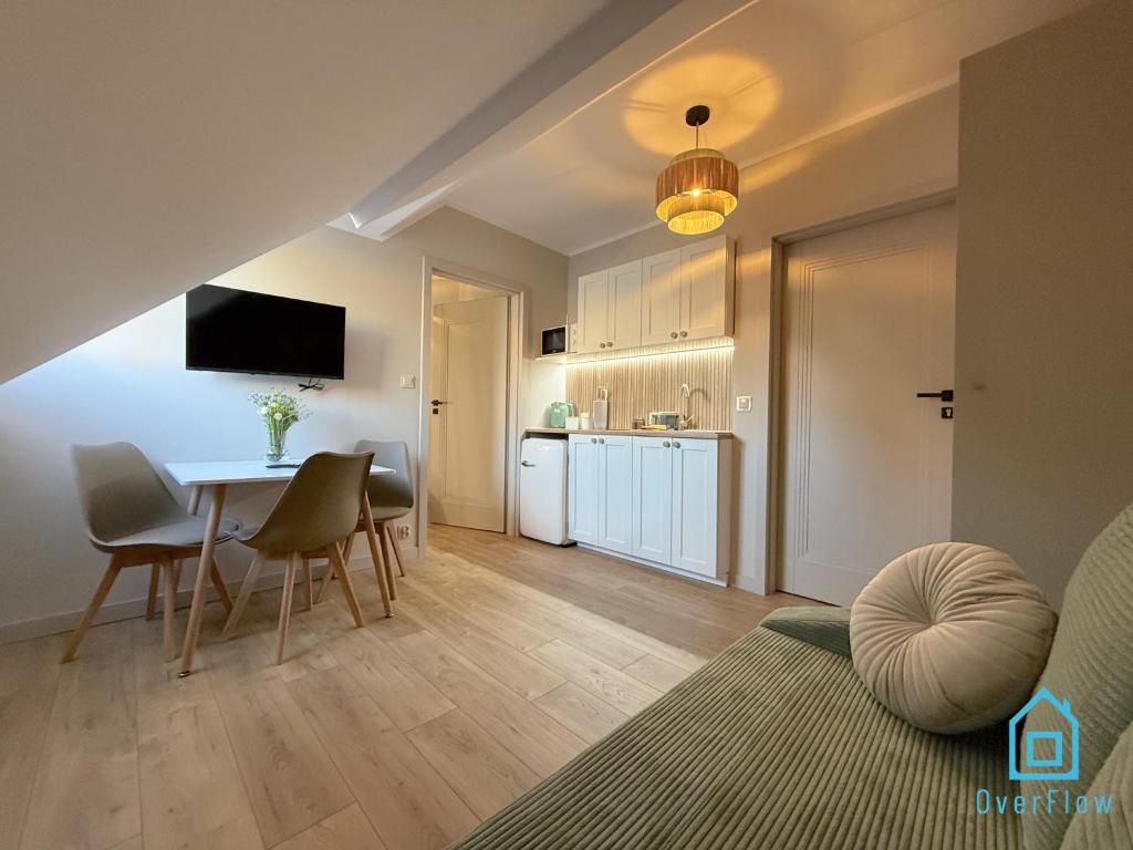 a kitchen and a dining room with a table and chairs at Casa Verde Apartment at Old Town Gdańsk in Gdańsk