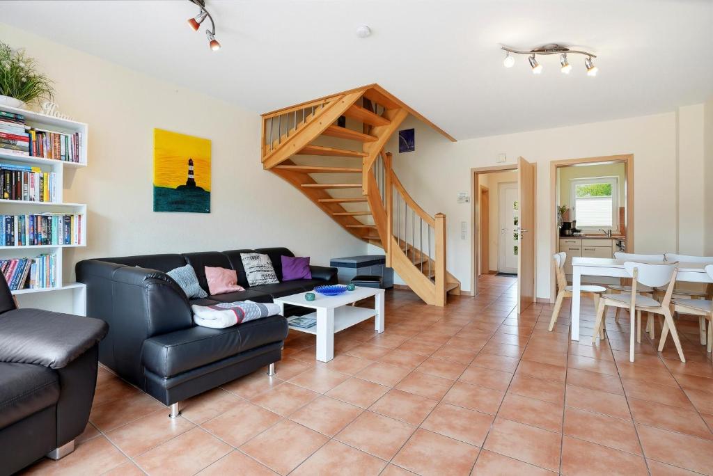 a living room with a couch and a staircase at Meeresbrise in Norddeich