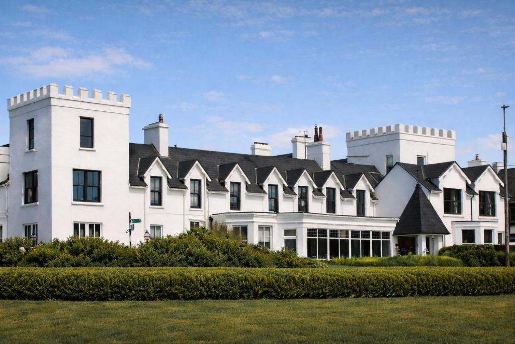 a large white building with a black roof at Butler Arms Hotel in Waterville
