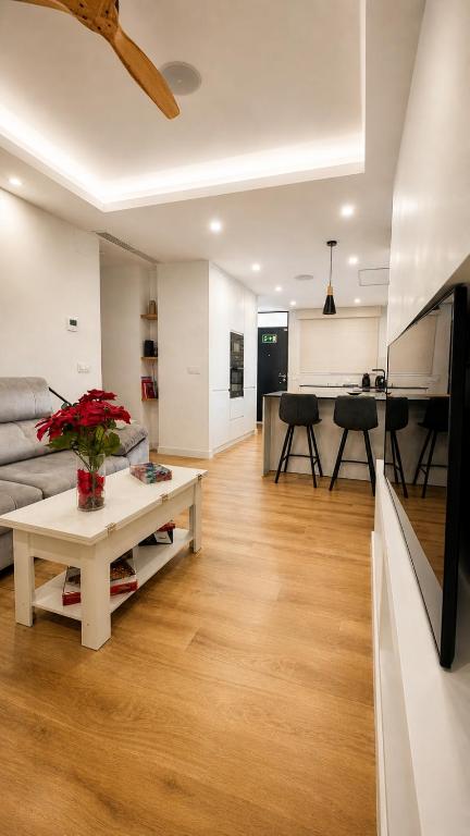 a living room with a couch and a table at Apartamento Luxe Triana in Seville