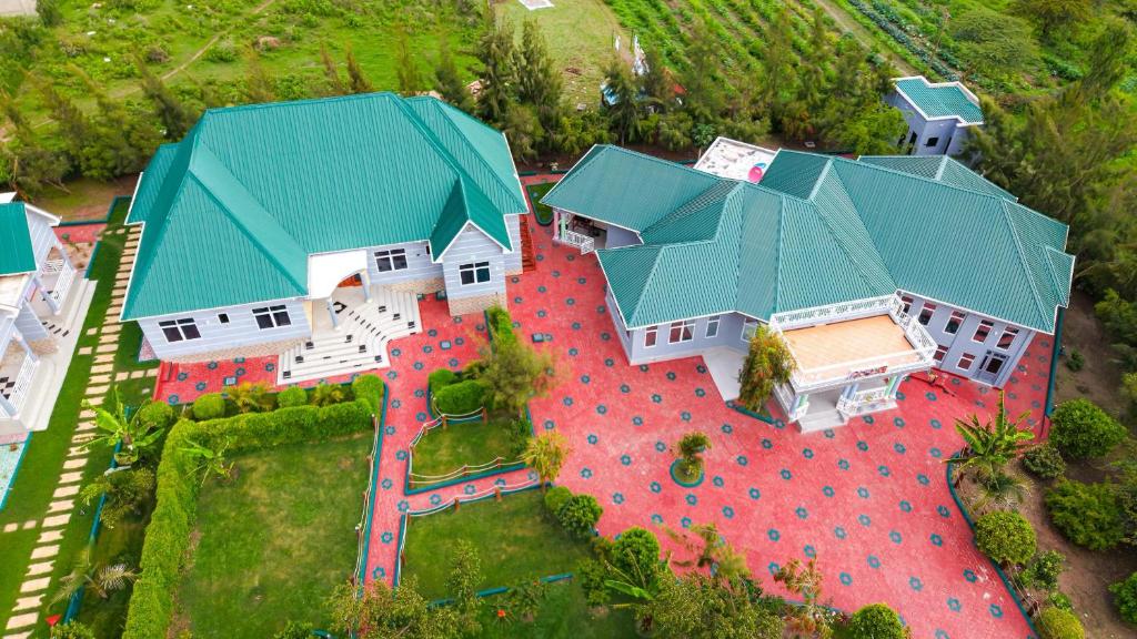 an overhead view of a large house with a green roof at JK Maasai Hotel in Wasso