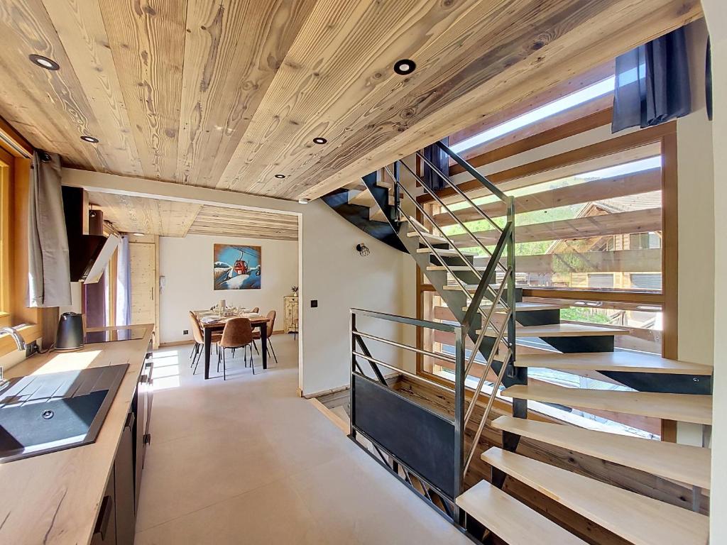 a spiral staircase in a kitchen with a dining room at Gervonne 2 in Morzine