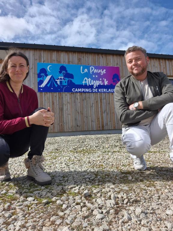 a man and a woman standing in front of a building at Camping Kerlaudy La pause Atypi'k in Plouénan