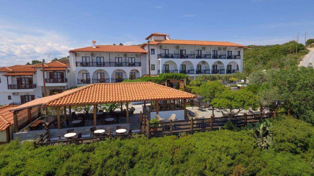 a large building with a gazebo on a hill at Sunset Hotel in Ouranoupoli