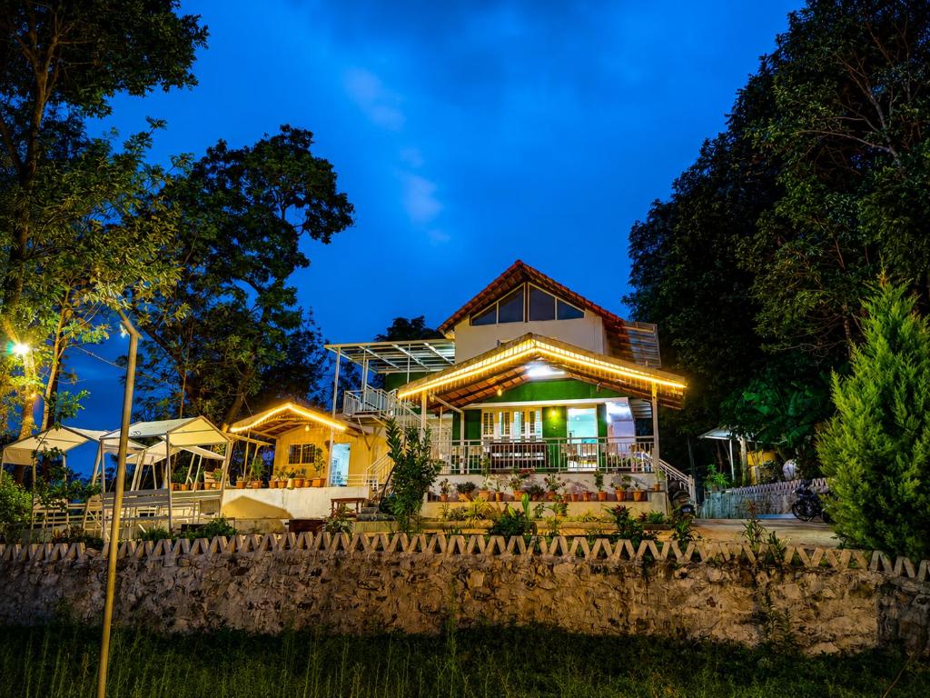 a house with a fence in front of it at night at Sunset Villa by Hyatt Stay in Avathi