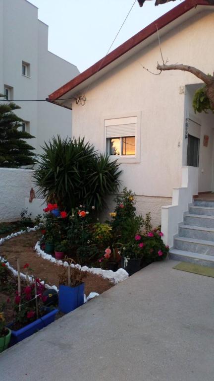 a house with flowers in front of it at Rachel in Nisís Áyios Nikólaos