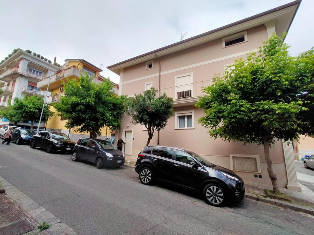 a row of cars parked next to a building at Sole & Mare in Palmi