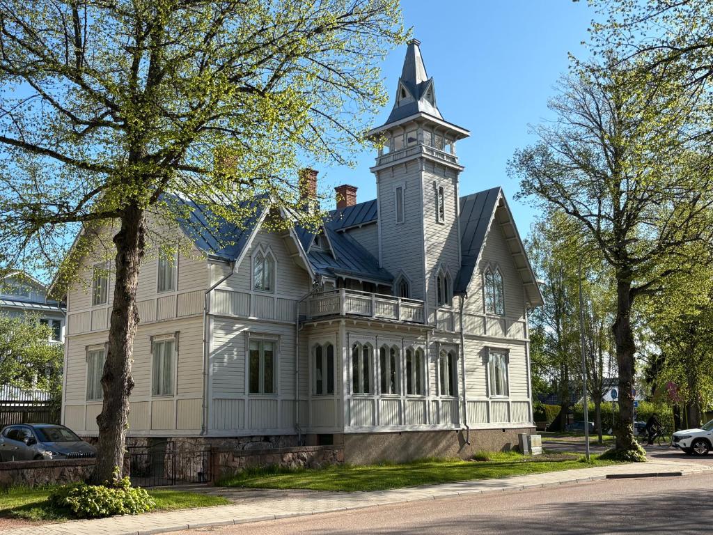 a large white house with a clock tower at Tornvillan in Mariehamn