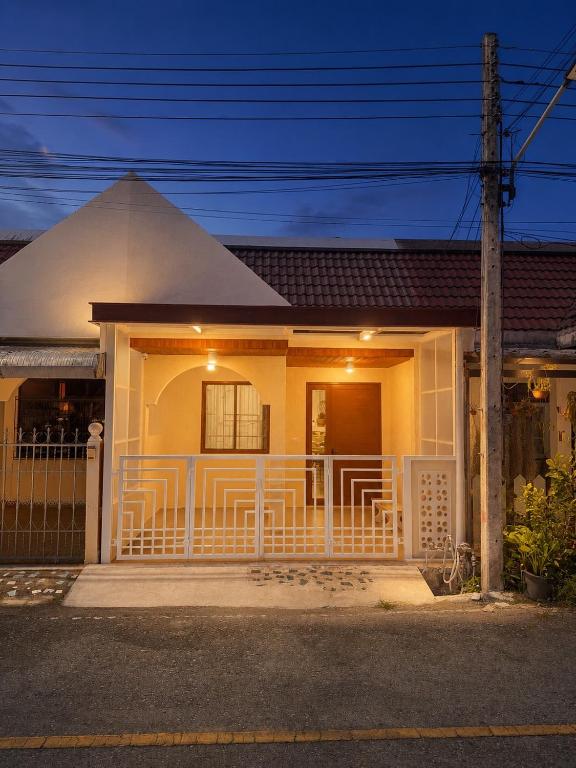 a house with a white fence in front of it at Cloud Nest House Betong in Betong