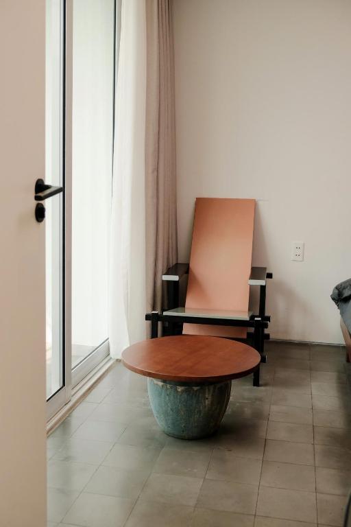 a table and a chair in a room at PHAM. Hotel & Views in Hai Phong