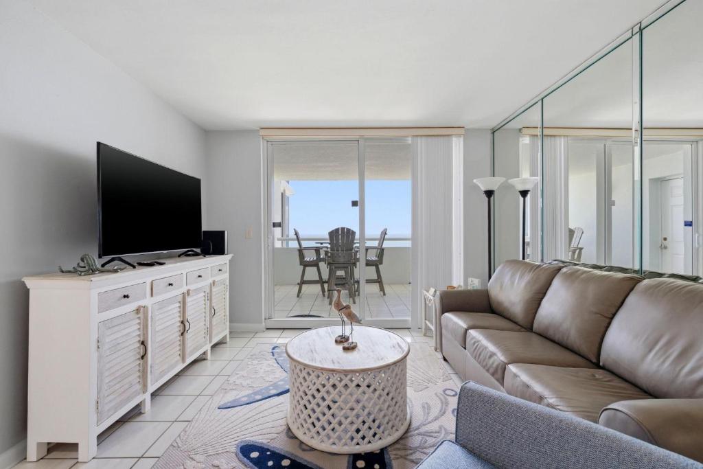 a living room with a couch and a tv at Perdido Sun 1008 in Perdido Key