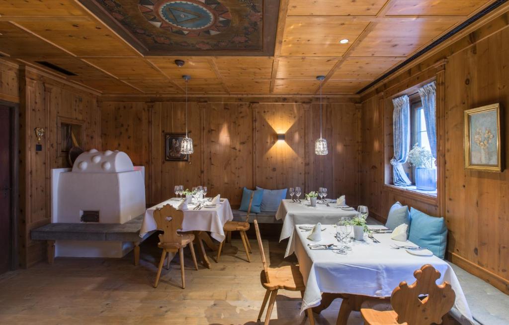 a dining room with tables and chairs and wooden walls at ElisabethHotel Premium Private Retreat- Adults only in Mayrhofen