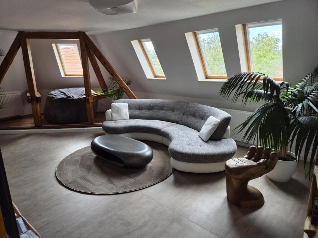 a living room with a couch and a chair at NEU! Über den Dächern von Mücheln in Mücheln