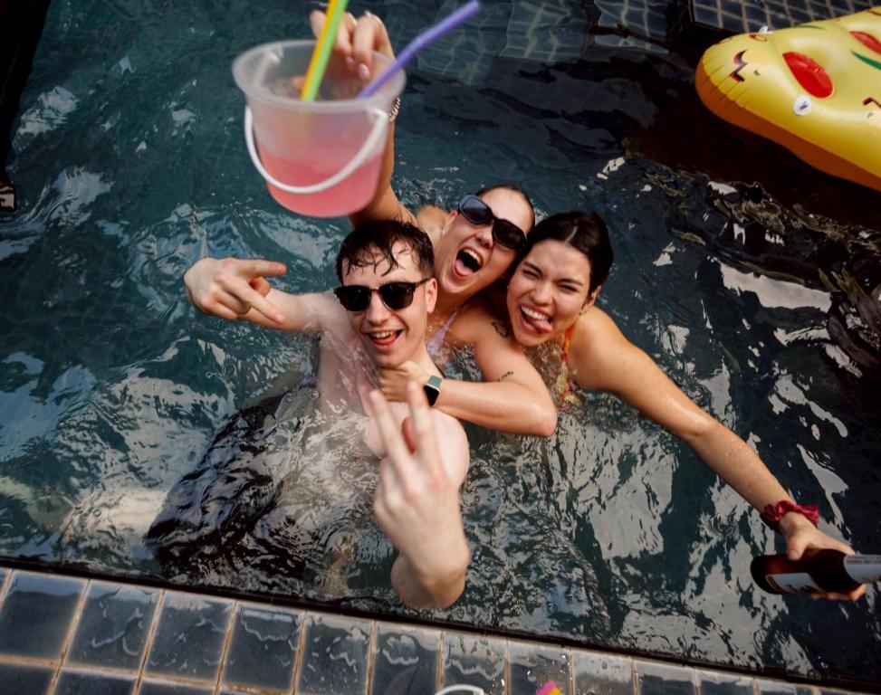 a group of people in a swimming pool at BED STATION Hostel Khaosan in Bangkok