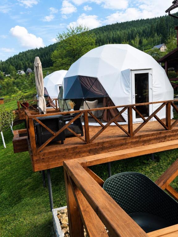 a yurt with umbrellas on a wooden deck at GSpace in Yaremche
