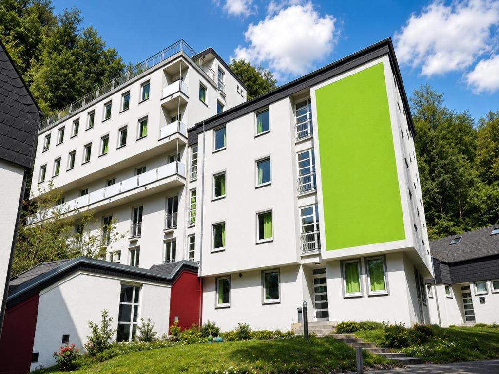 a building with a green sign on the side of it at Bendorf Hotel by Belvilla in Bendorf