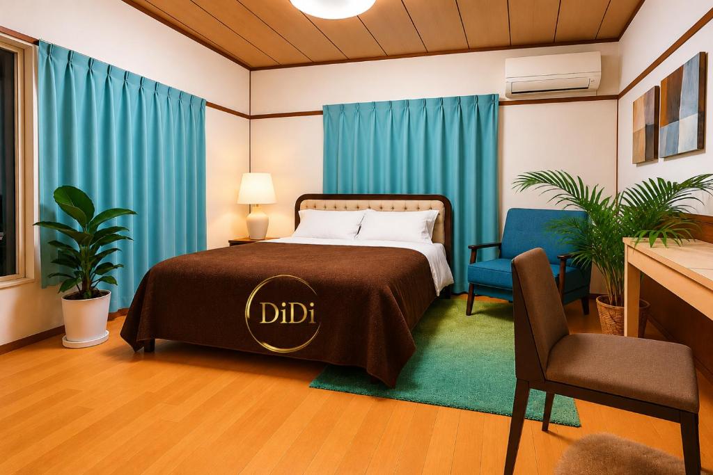 a bedroom with a bed with blue curtains and a chair at DiDi Calm 105 in Tokushima