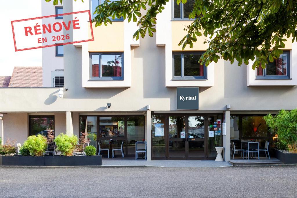 a facade of a building with a restaurant at Kyriad Hotel Strasbourg Lingolsheim in Lingolsheim