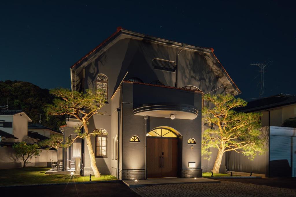 a church building with a door at night at SOSHIJI Arashiyama in Kyoto