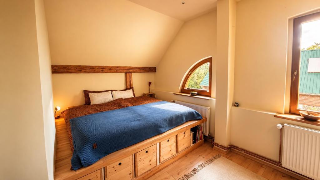 a bedroom with a bed with a blue blanket at Pauline 3 in Templin