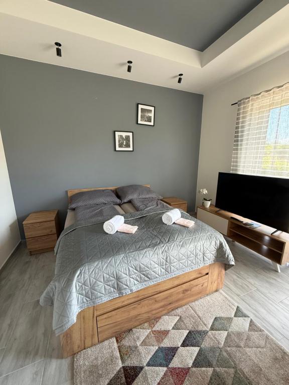 a bedroom with a bed with two towels on it at ILK Residence 3 in Balatonalmádi