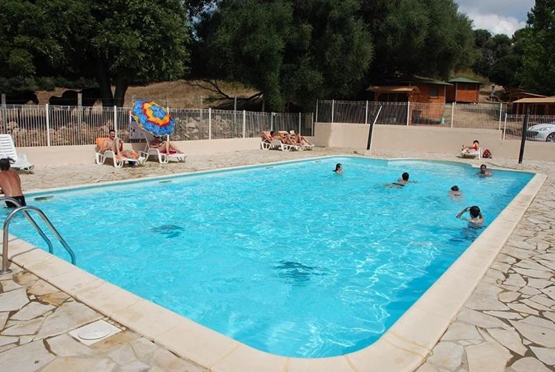 a group of people swimming in a swimming pool at Camping 3 étoiles - Piscine - ccbfihb in Casaglione