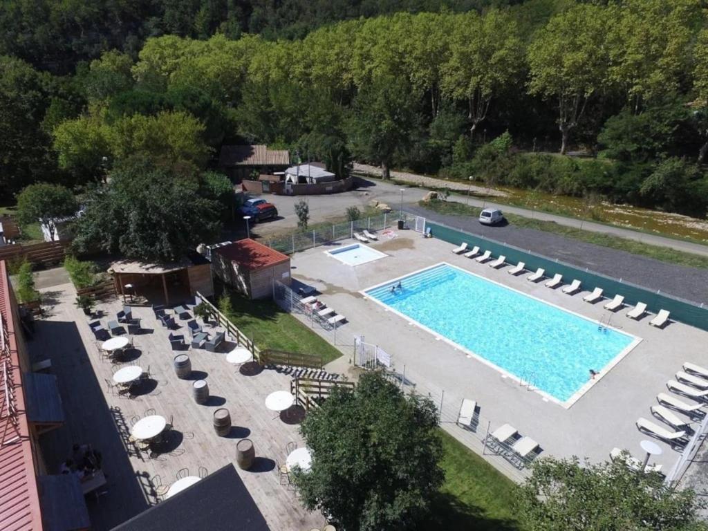 an overhead view of a swimming pool with lounge chairs and a resort at Camping 3 étoiles - Piscine - ccbgccf in Rennes-les-Bains